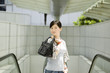 asian girl with handbag outdoors