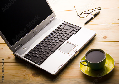 Photo: laptop and a cup of coffee laptop and a cup of coffee