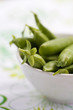 Fresh peas in white bowl, shallow focus