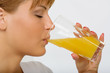 Close up look on a pretty girl drinking orange juice Close up look on a pretty girl drinking orange juice