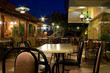 Tables and chairs in a greek restaurant at night Tables and chairs in a greek restaurant at night
