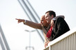 Photo: Two businessmen standing on bridge Two businessmen standing on bridge