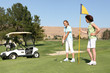 Photo: Two pretty young woman golfing on the course Two pretty young woman golfing on the course