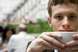 The young man drinking coffee in cafe