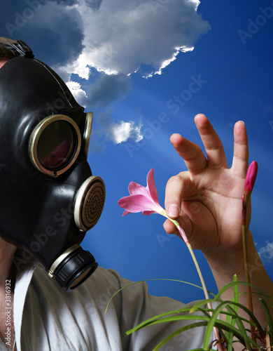Photo: The man in a gas mask with flowers The man in a gas mask with flowers