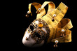 Golden Venetian mask, isolated on black background.