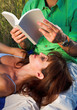 couple reading a book outdoor at sunset