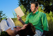 couple reading a book outdoor at sunset