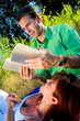 couple reading a book outdoor at sunset