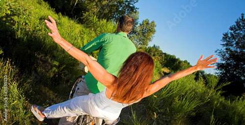 couple enjoying the sunset outdoor with a bicycle