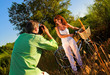 couple playing outside on a field taking pictures