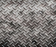 a very large sheet of rough black diamond plate with pits 