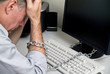 A man feeling as if he is chained to his computer 