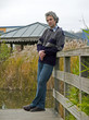 Relaxed middleaged man standing at a landing place