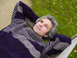 Relaxed middleaged man lying on a bench looking in the sky