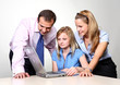 Three colleagues working at a computer.