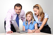 Three colleagues working at a computer.