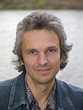 Middleaged man in a jean suit and a shirt close up portrait