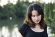 Peaceful and thoughtful latin brunette girl in a black blouse