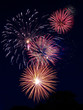 Cluster of gold, pink, red, blue, white fireworks