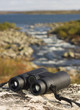 binocular on a hilltop overlooking a lake