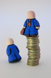 two mens statuette: subordinate and boss(on coins rouleau)