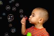 Boy blowing soap bubbles