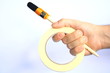 Hand with paintbrush and painters tape Hand with paintbrush and painters tape