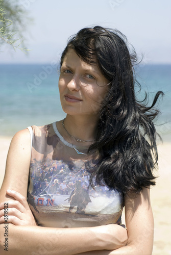 Photo: pretty young woman smiling thoughtful greek island beach pretty young woman smiling thoughtful greek island beach
