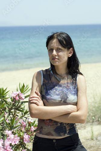 Photo: pretty young woman with emotional attitude on beach pretty young woman with emotional attitude on beach