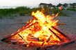 A beautiful campfire is on the beach.
