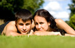 Happy couple lying on grass.