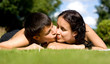 Happy couple lying on grass.