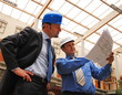 Foto: architect and supervisor Reviewing Blueprints architect and supervisor Reviewing Blueprints