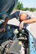 Businessman opening the trunk and checking the engine of a car Businessman opening the trunk and checking the engine of a car