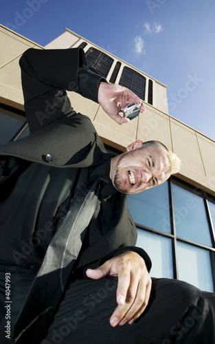 Photo: Frustrated Punk Businessman on his Cell Phone Frustrated Punk Businessman on his Cell Phone