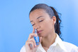 young pretty girl holding perfume