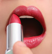 Applying lipstick
