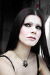 Gothic pale skin woman in cemetery close-up