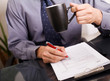 businessman signing papers