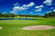 Putting green,  a pond, and a bunker on a golf course