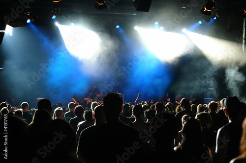 Cheering crowd at concert, musicians on the stage Cheering crowd at concert, musicians on the stage