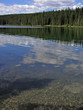 Cloud reflections in a forest lined lake Cloud reflections in a forest lined lake