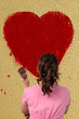 Girl painting a big heart