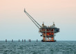 Oil Drilling Rig offshore in late afternoon light Oil Drilling Rig offshore in late afternoon light