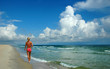 Woman walking on Shore Woman walking on Shore