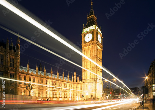 Big Ben in London at night against blue sky. London traffic