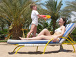 boy playing with his mother on the beach