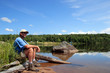 Man sitting near a lake