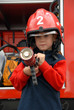 A young boy sitting in a fire truck A young boy sitting in a fire truck